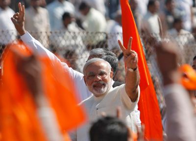 Narendra Modi gestures after taking his oath as chief minister during a swearing-in ceremony in Ahmedabad