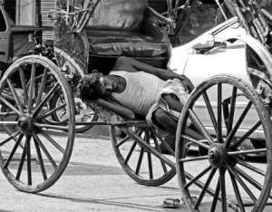 A rickshaw puller takes a quick nap. Photo by Sirsendu Gayen in Kolkata.