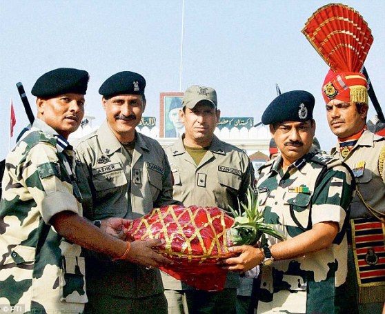 The BSF presents a sweets basket to Pakistani Rangers on the occasion of Eid-ul-Zuha at Wagha Border in Amritsar. Courtesy Daily Mail and PTI. Dated: August, 2013